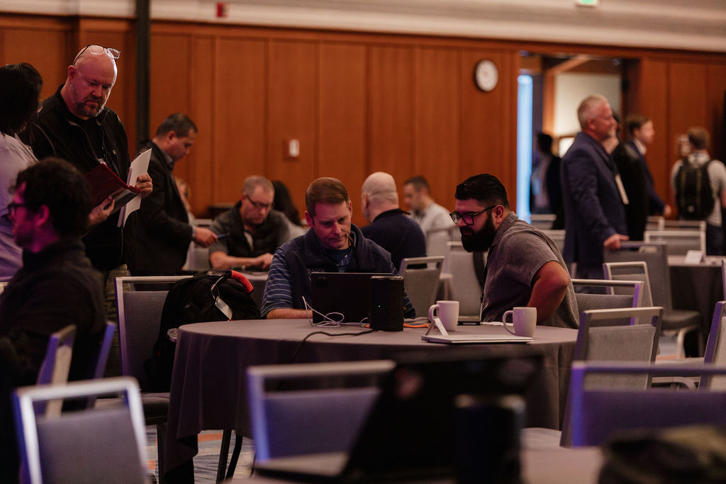 Attendees collaborating at round tables during a working session