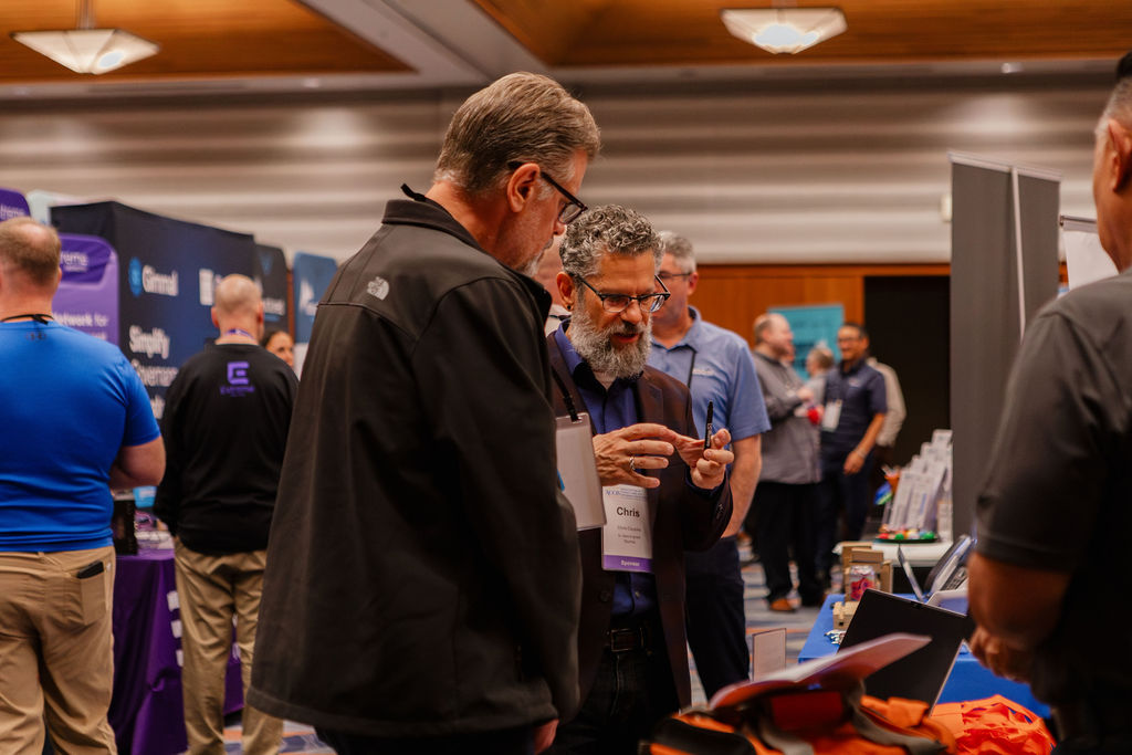 An Industry Partner demonstrating a product to an attendee in the Showcase