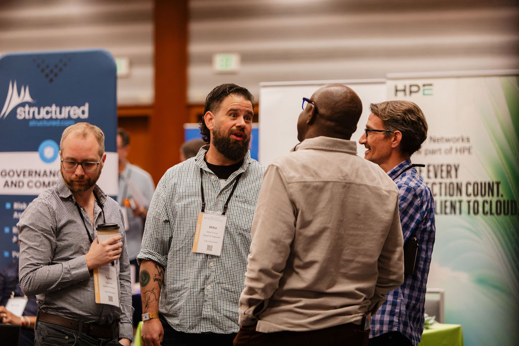 Partners and attendees in conversation between Showcase tables