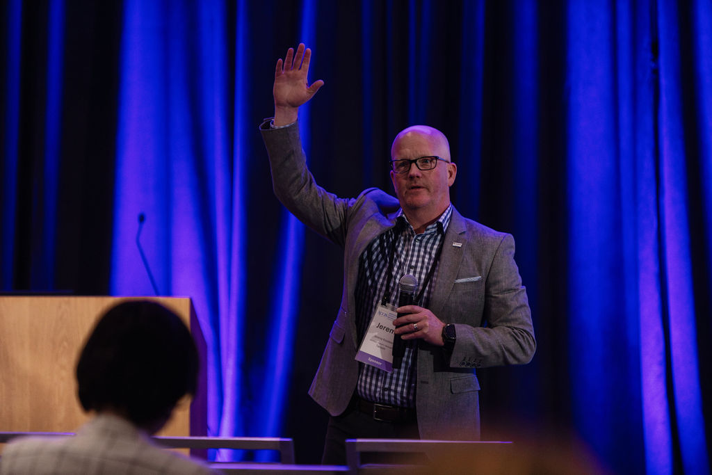 A speaker presenting on the mainstage at the ACCIS Spring 2026 Conference